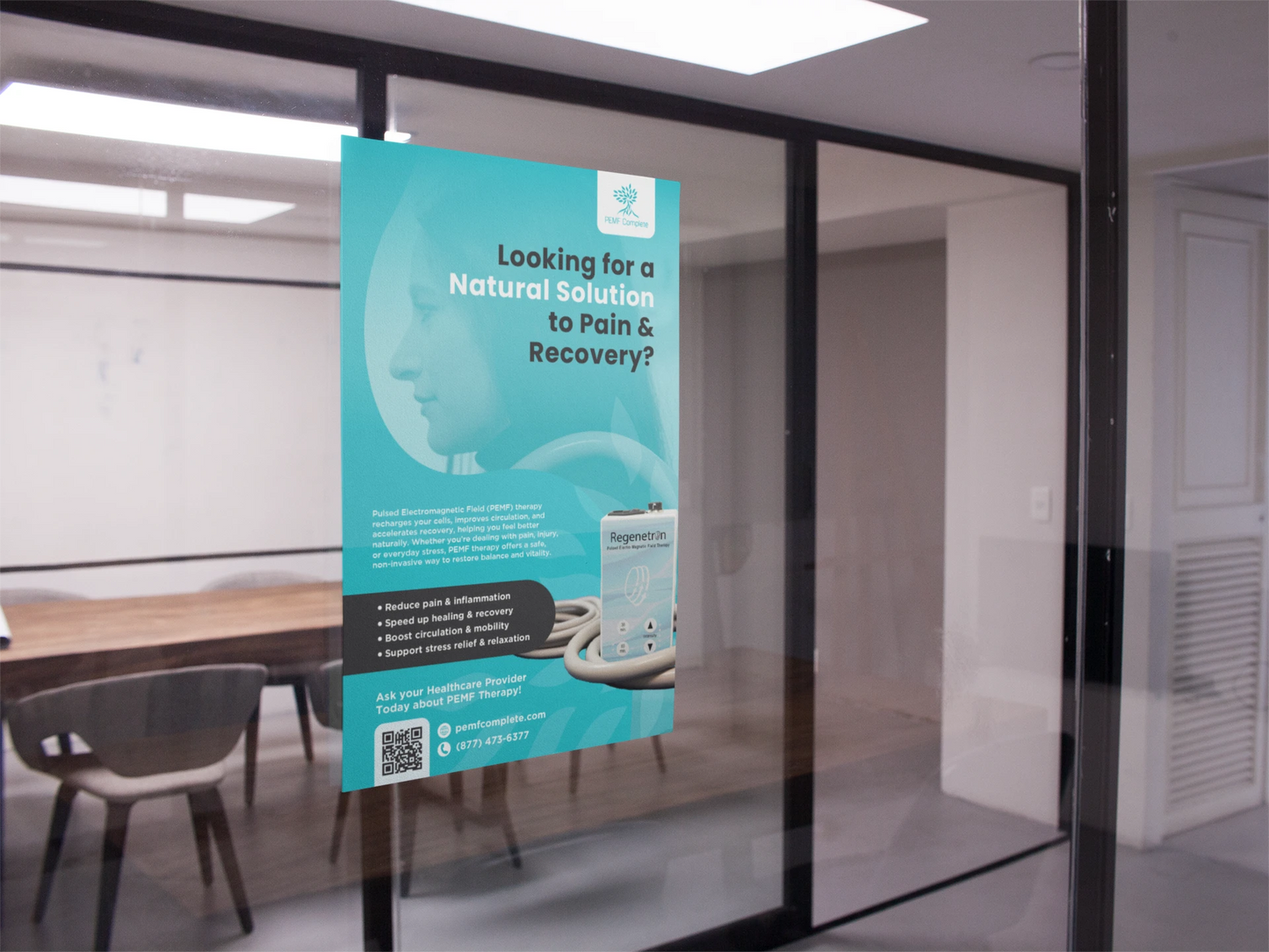 Teal PEMF Complete poster hanging on a glass wall in an office setting