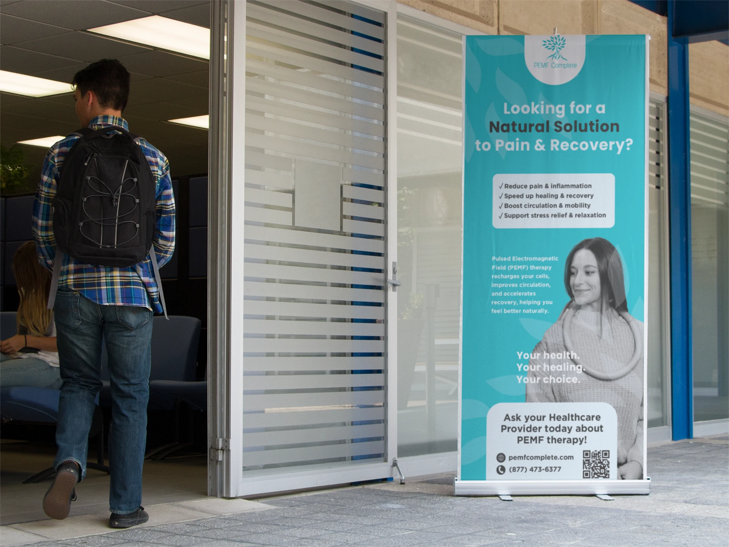 Promotional banner for PEMF therapy outside a building entrance