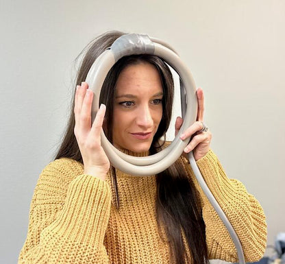 Woman with PEMF loop held up to face