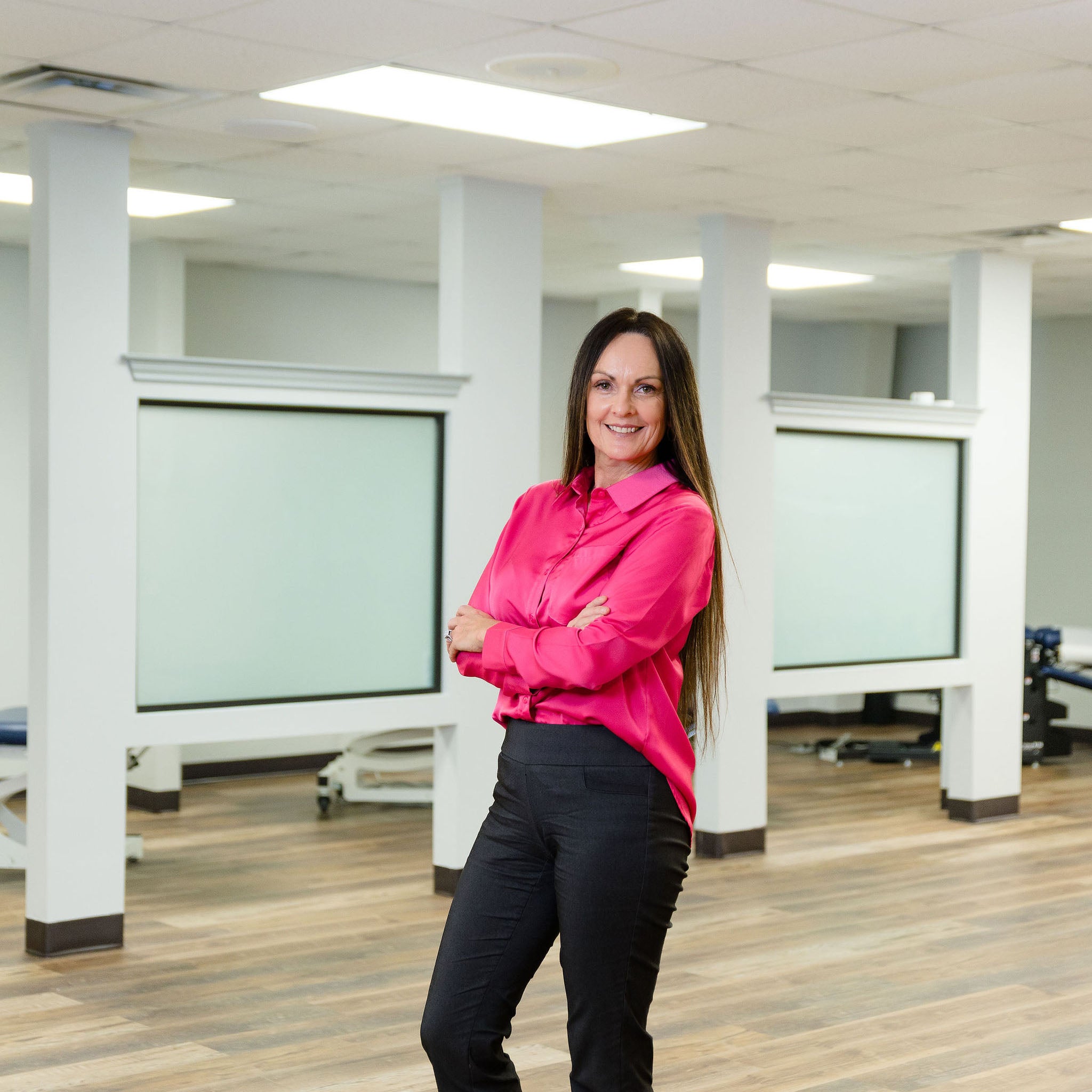 Stephanie Walters of PEMF Complete standing with arms crossed and smiling